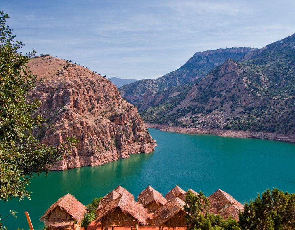 Scenic lake surrounded by red mountains and resort rooftops