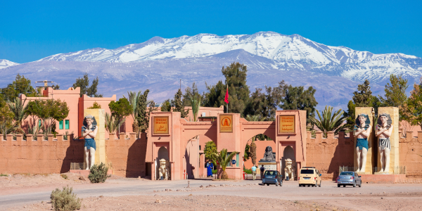 City gate in Morocco with snow-covered Atlas Mountains behind