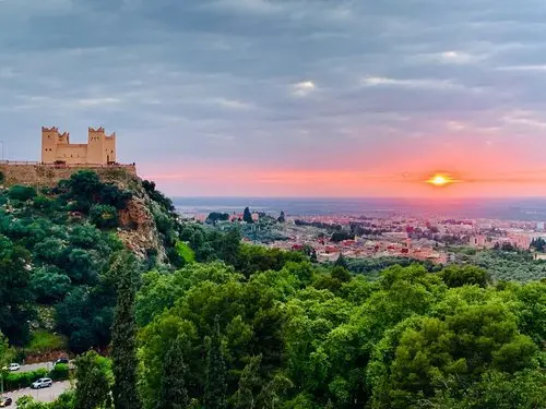 Moroccan fortress overlooking a forest at dusk