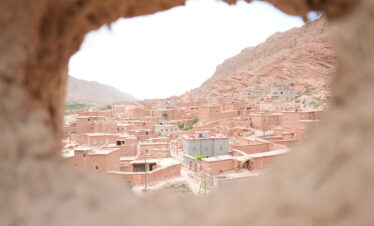 Moroccan village seen through a natural rock window