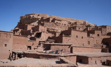 Historic Moroccan village built with reddish mudbrick walls