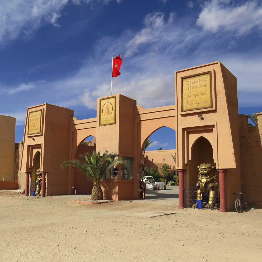 Moroccan-style gate adorned with flags and traditional architecture