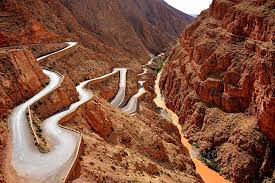 Winding mountain road cutting through dramatic Moroccan cliffs