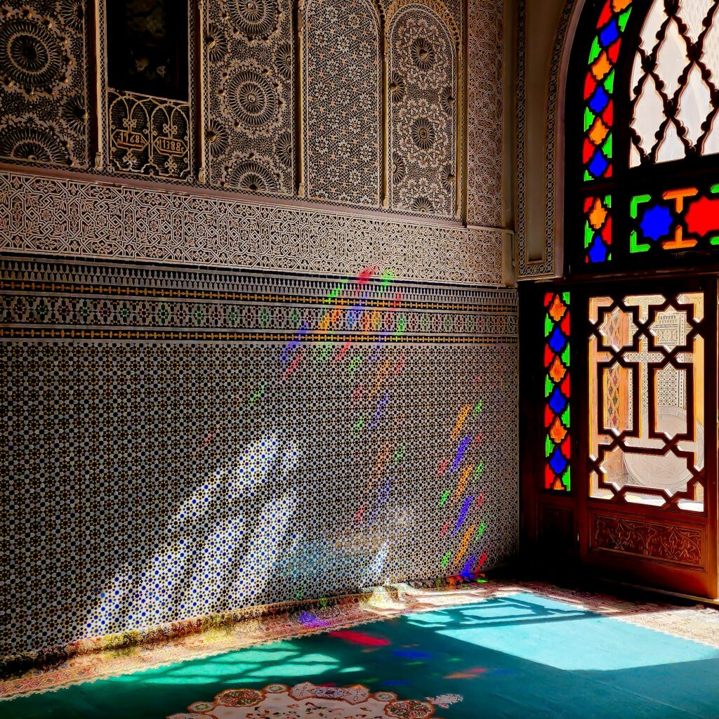 Blue steps leading up to a Moroccan home with arched entry