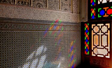 Blue steps leading up to a Moroccan home with arched entry