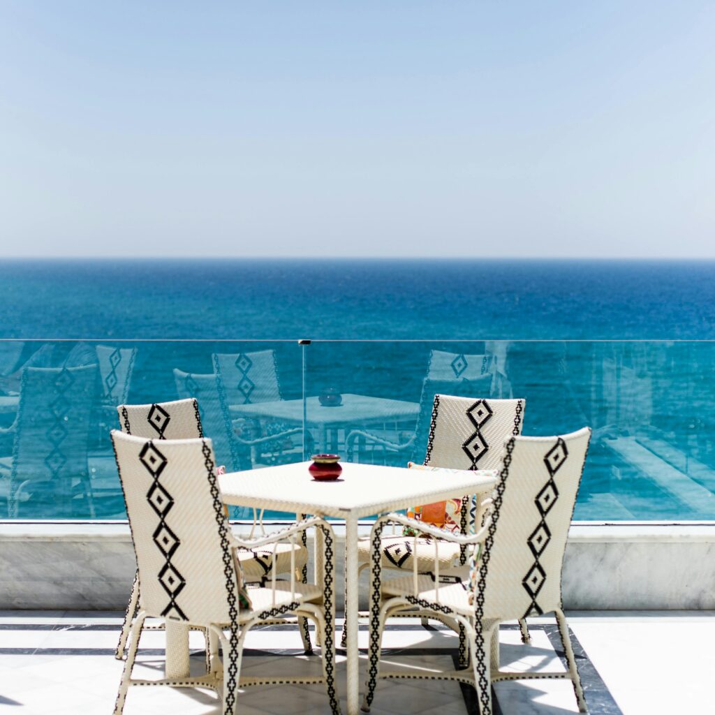 Moroccan outdoor café with ocean view and white furniture