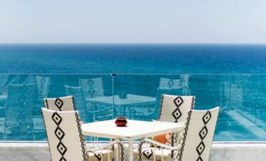 Moroccan outdoor café with ocean view and white furniture