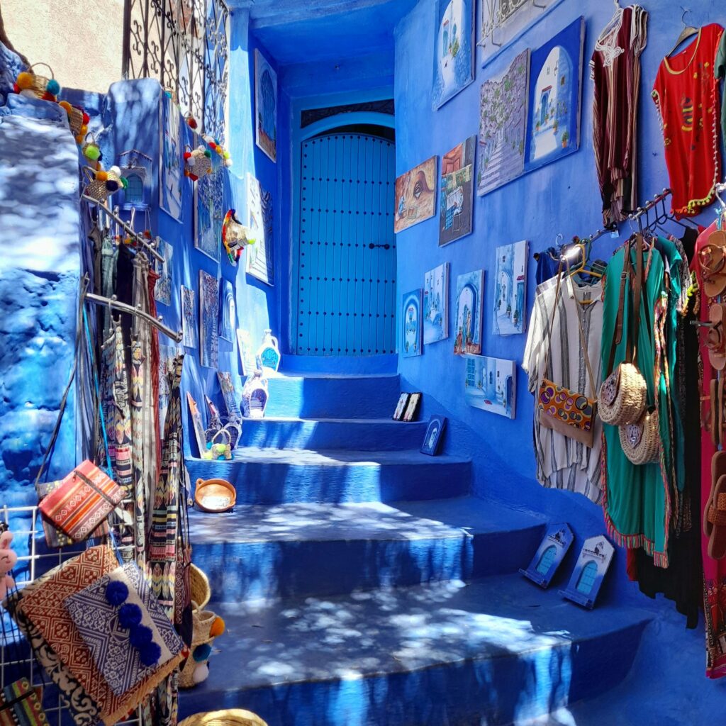 Blue staircase decorated with potted plants in Chefchaouen