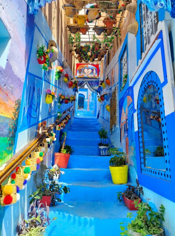 Narrow alley painted in various shades of blue in Chefchaouen