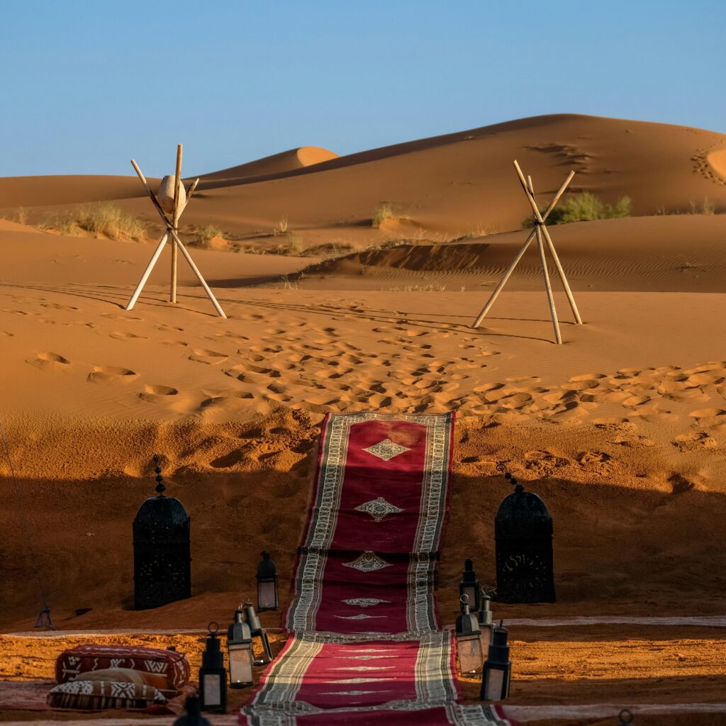 Traditional Moroccan tent with red carpets in the desert