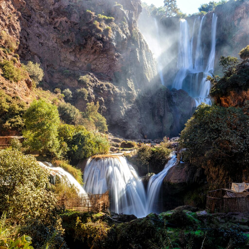Cascading waterfall surrounded by rocky cliffs and trees