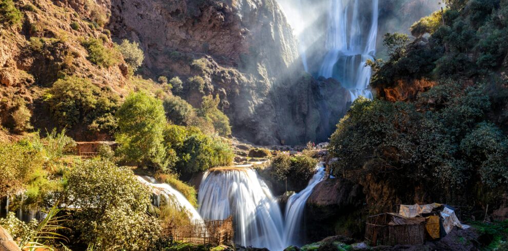 Cascading waterfall surrounded by rocky cliffs and trees
