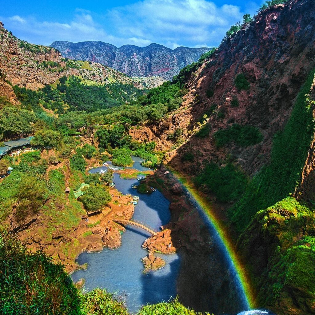 Lush valley with river and rainbow