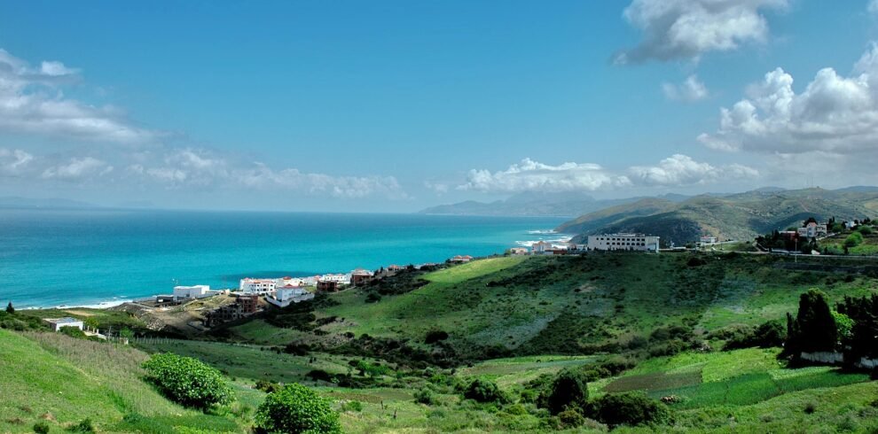 Rooftop view of Moroccan city with Atlantic Ocean in background