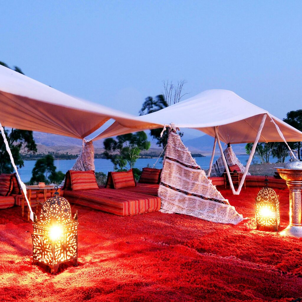 Elegant desert tent setup with glowing lanterns in Morocco