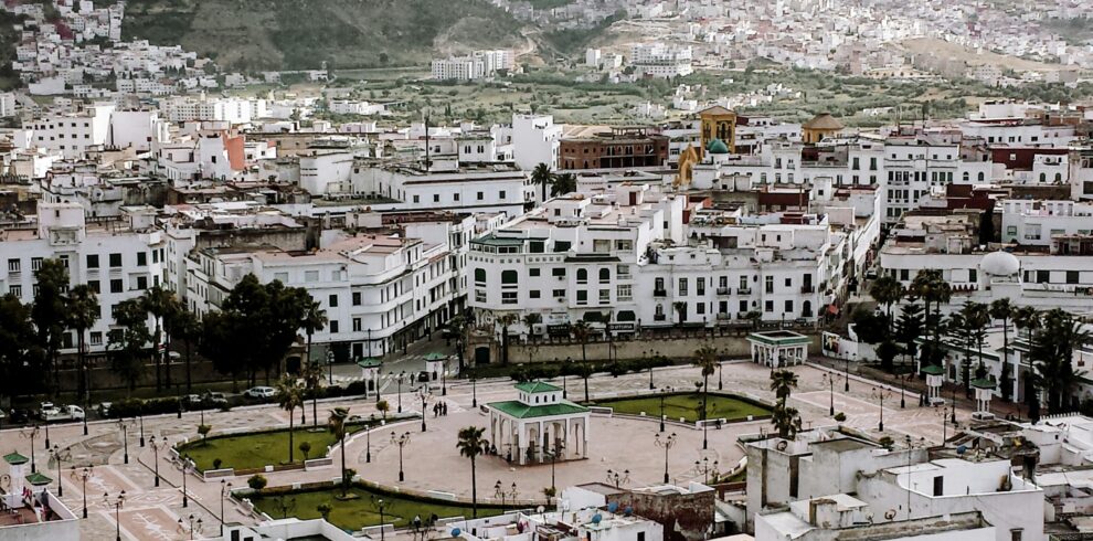 White buildings nestled in lush green mountains