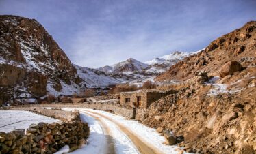 Winding road through snowy Atlas Mountains in Morocco