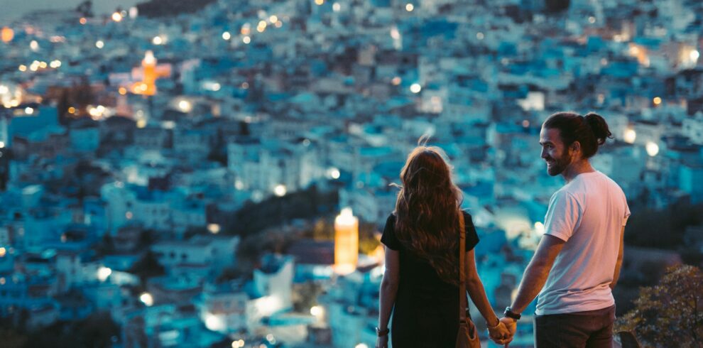 Couple walking hand-in-hand in Chefchaouen’s blue medina