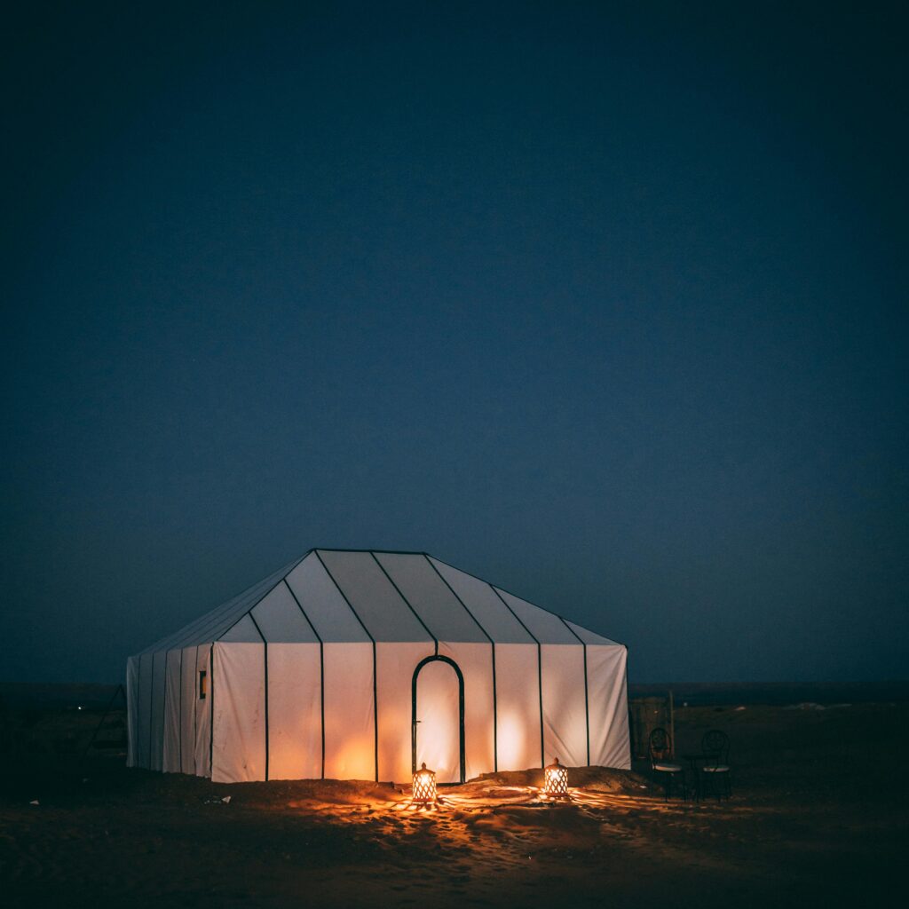 Illuminated luxury tent in Moroccan desert at night