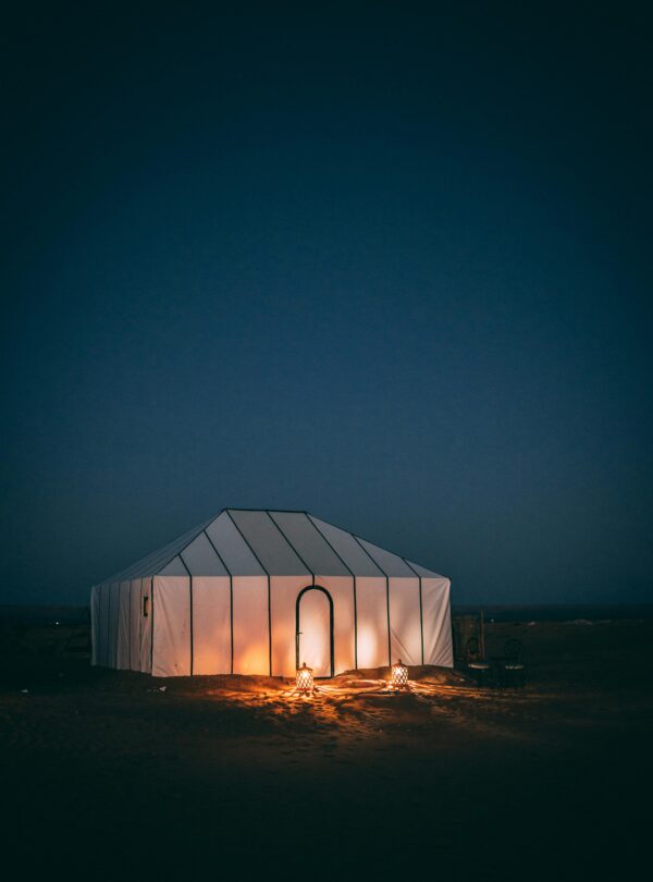 Illuminated luxury tent in Moroccan desert at night