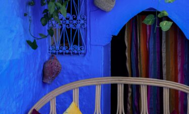 Blue doorway in Chefchaouen decorated with flower pots