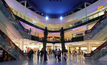 Shoppers beneath glass dome in large mall