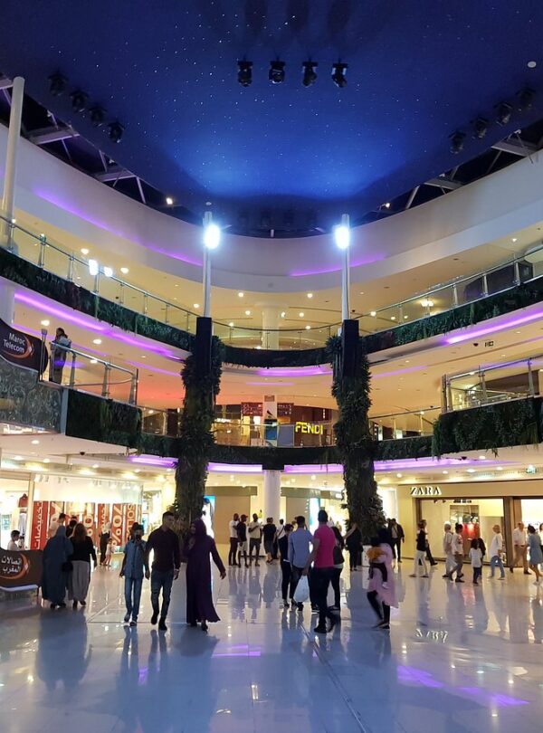 Shoppers beneath glass dome in large mall