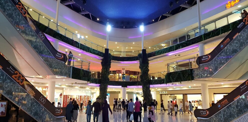 Shoppers beneath glass dome in large mall