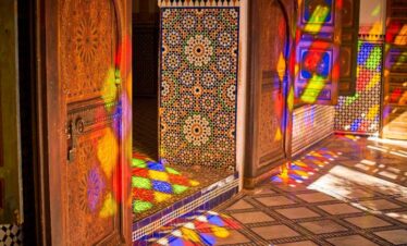 Woman in blue dress in ornate Moroccan palace room
