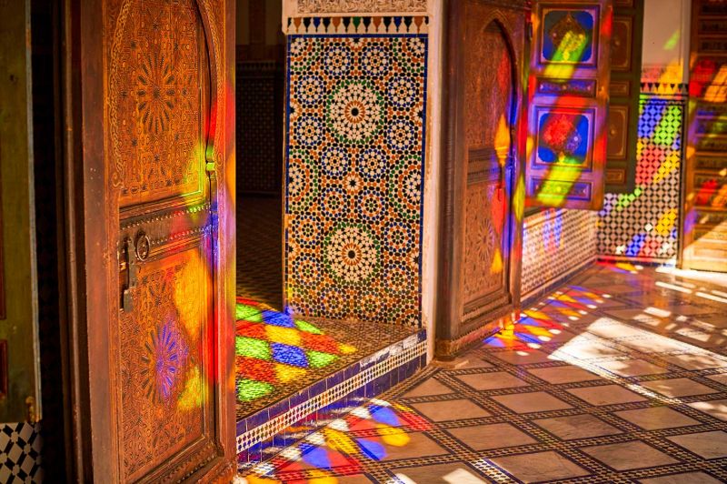 Woman in blue dress in ornate Moroccan palace room