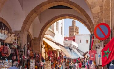 Market alley with hanging goods and red arch