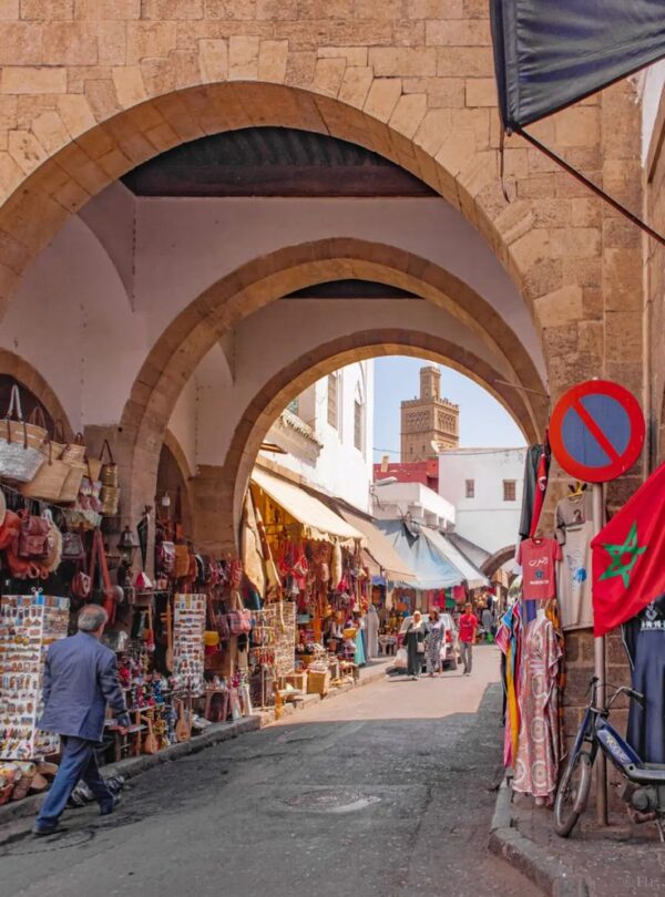 Market alley with hanging goods and red arch