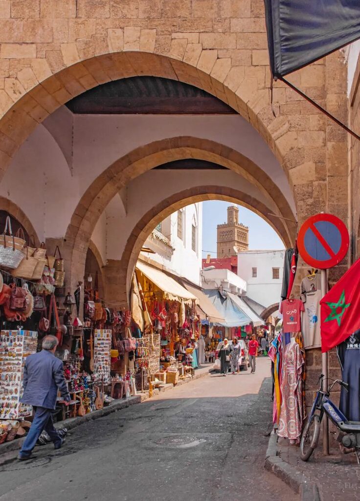 Market alley with hanging goods and red arch