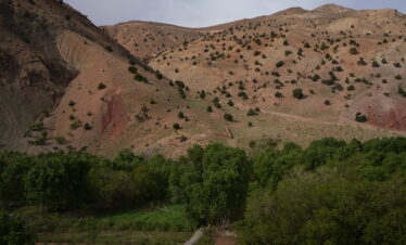 Lush green valley surrounded by rocky hills in Morocco.