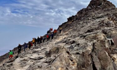 Hikers climbing a rocky trail
