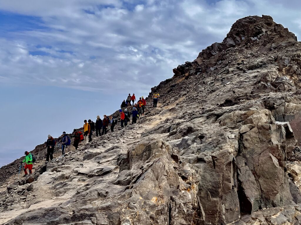 Hikers climbing a rocky trail