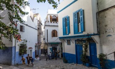 Stone alley with blue windows and white walls