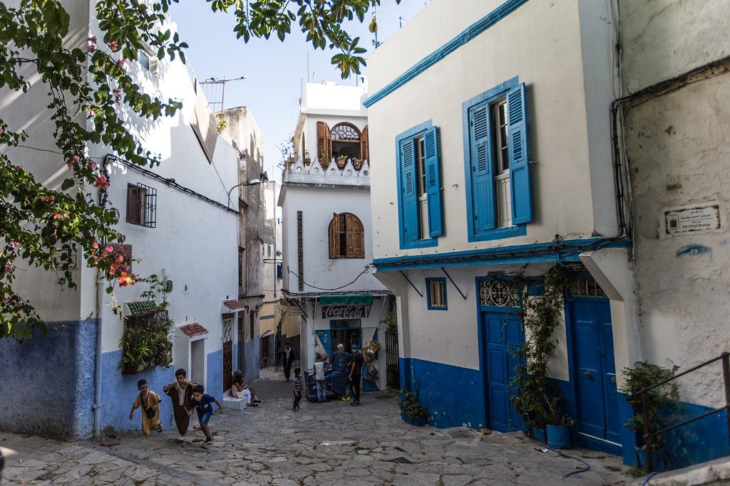 Stone alley with blue windows and white walls