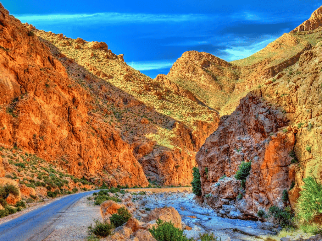 Narrow valley with rugged red rock formations in Morocco.