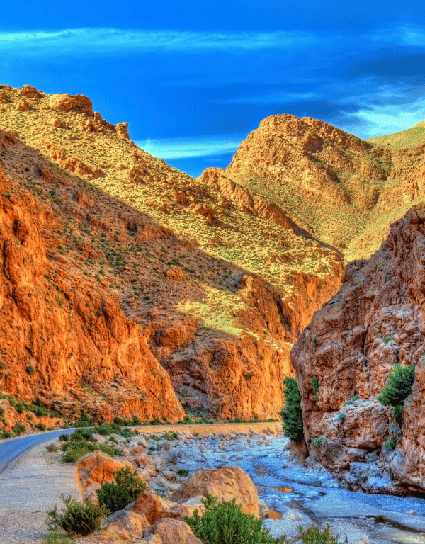 Narrow valley with rugged red rock formations in Morocco.