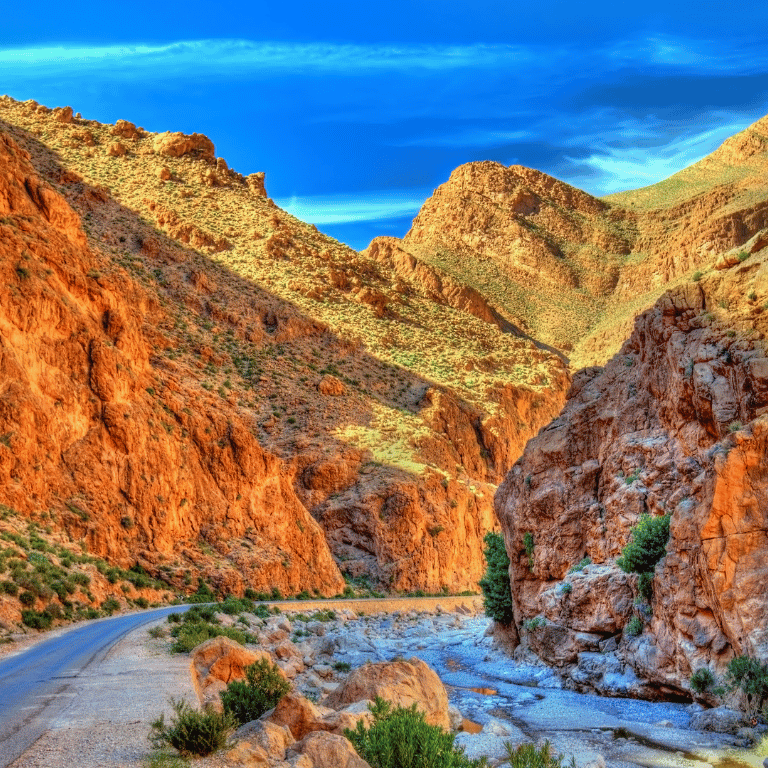 Narrow valley with rugged red rock formations in Morocco.