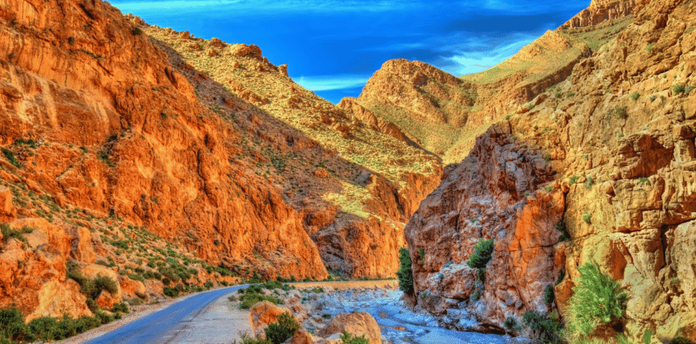 Narrow valley with rugged red rock formations in Morocco.