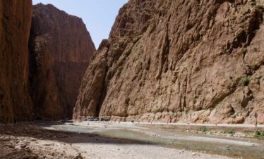 Rocky canyon walls and a walking path in Todgha Gorge.