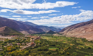 A broad, fertile valley with agricultural terraces.
