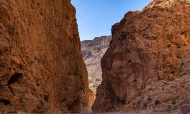 Natural rock cave tunnel in a Moroccan canyon.