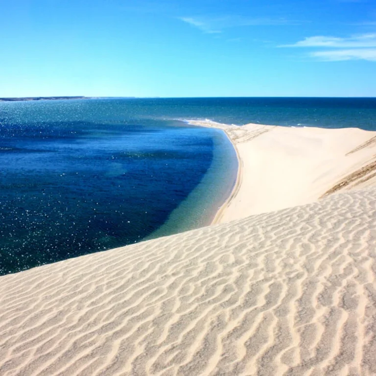 Natural sandbar surrounded by blue water