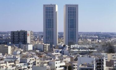 Two tall modern towers above a city
