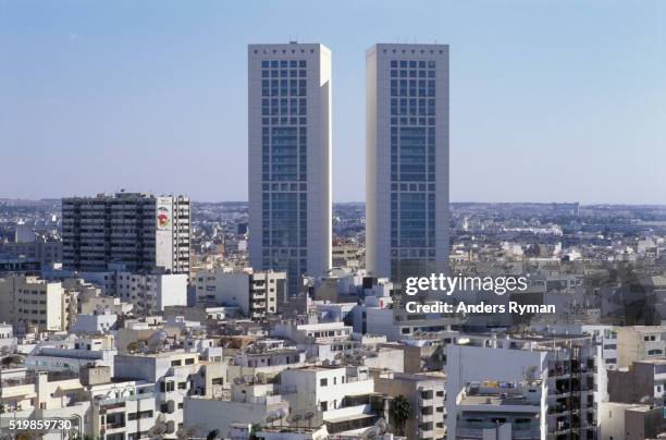 Two tall modern towers above a city