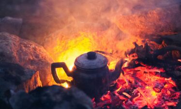 Tea kettle over open desert fire
