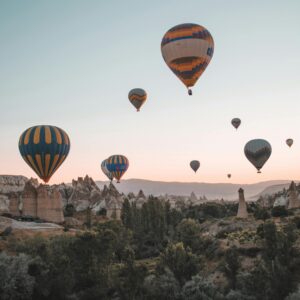 Balloons floating over desert scenery
